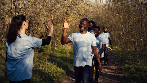 Activists congratulating each other with a high five after a successful teamwork