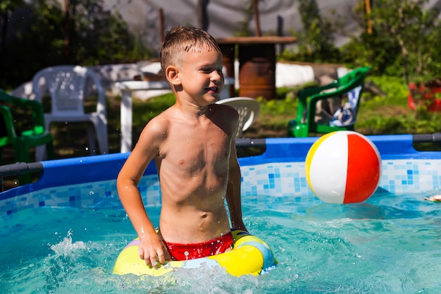 Activities on the pool children swimming and playing in water happiness and summertime