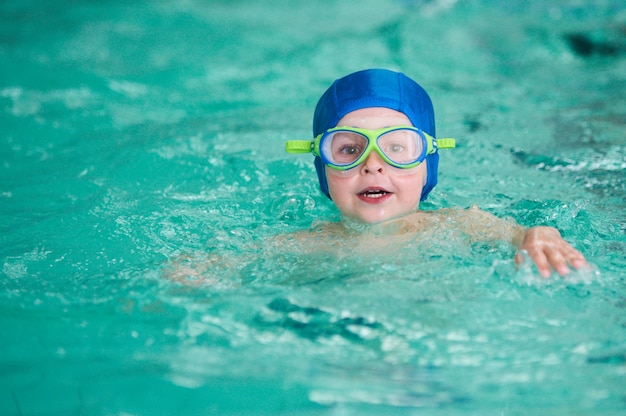 Activities on the pool, children swimming and playing in water