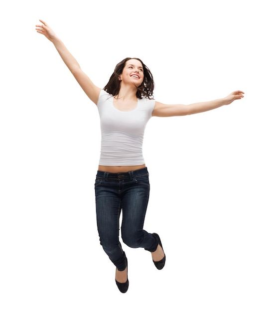 Activity and happiness concept - smiling teenage girl in white blank t-shirt jumping