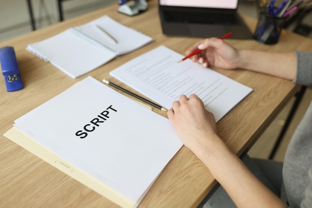 Actress checks script papers for filming movie making notes with pencil woman edits text at