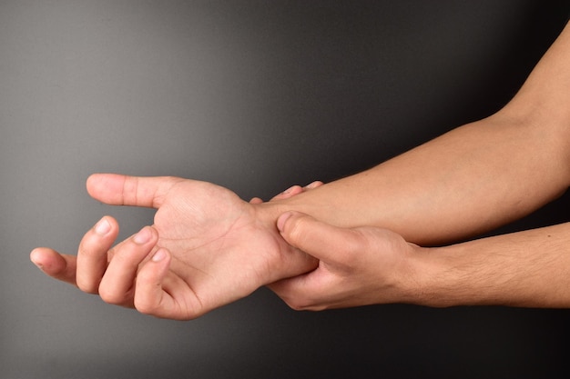 acupressure hand doing self treatment acupressure on black background