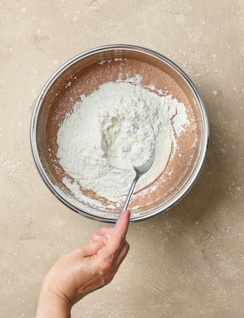 Add flour to the bowl of chocolate cake dough, top view