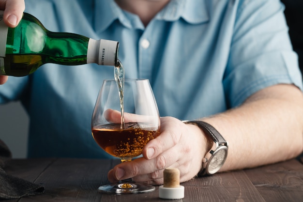 Addict issue, man pours himself a whiskey