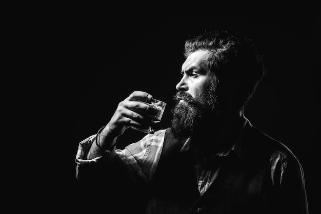 Addicting to alcoholic drink Alcoholism Handsome stressed businessman in formal wear holding a glass