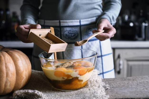 Adding spices in the dough for pumpkin dump cake