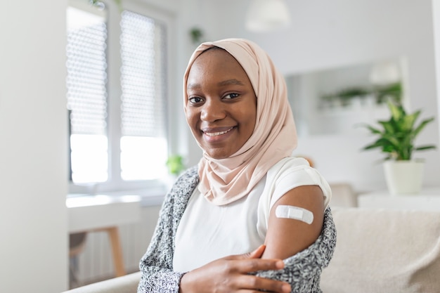 Adhesive bandage on arm after injection vaccine or medicine,ADHESIVE BANDAGES PLASTER - Medical Equipment,Soft focus Adhesive bandage on a muslim african female brachium after covid-19 vaccination