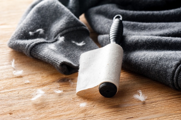 Adhesive lint roller full of dust closeup