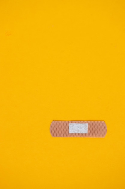 Adhesive plaster on yellow background