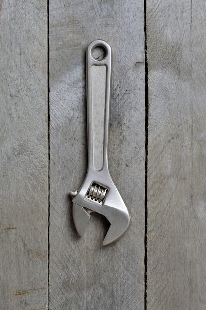 Photo adjustable spanner on wooden