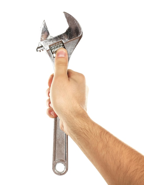 Adjustable wrench in male hand isolated on white