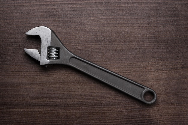 Adjustable wrench on the wooden table