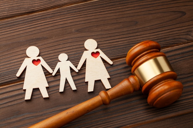 adoption of child by samesex couple judge gavel and figures of two lesbian girl child hold hands