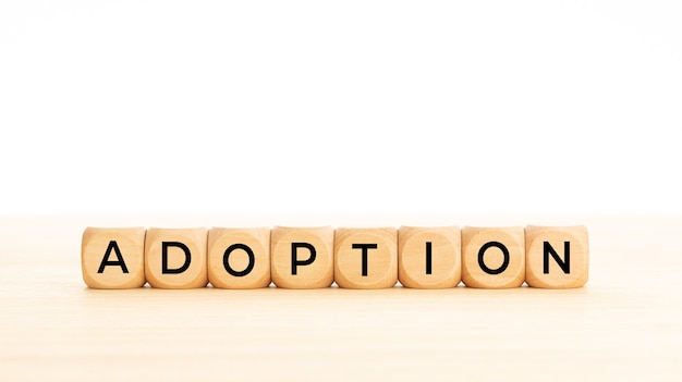 Adoption word on wooden blocks. Copy space. White background