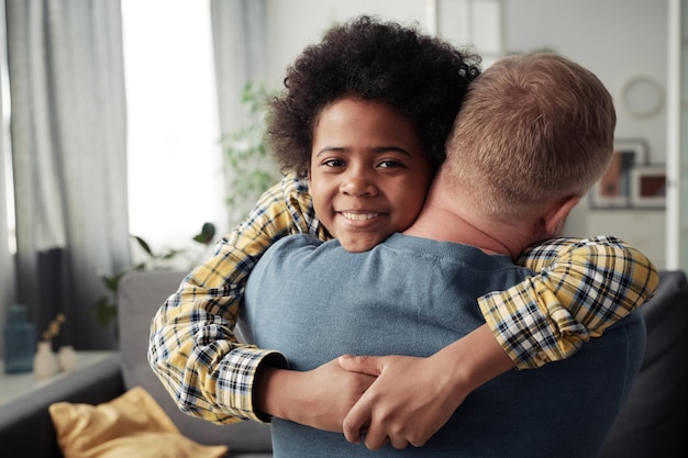 Adoptive boy embracing his foster dad