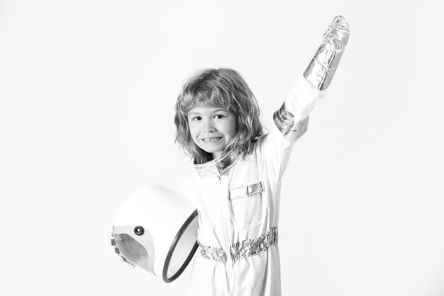 Adorable amazed boy astronaut in outer space Child imagines himself to be an astronaut holding helmet