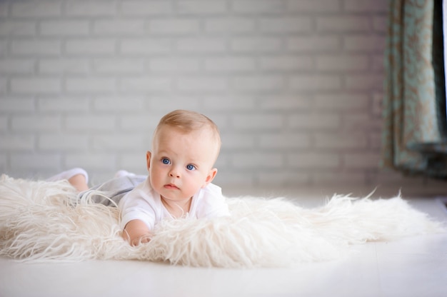 Adorable baby boy learning to crawl and playing 