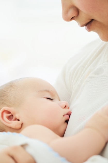 Adorable baby boy in mother's arms