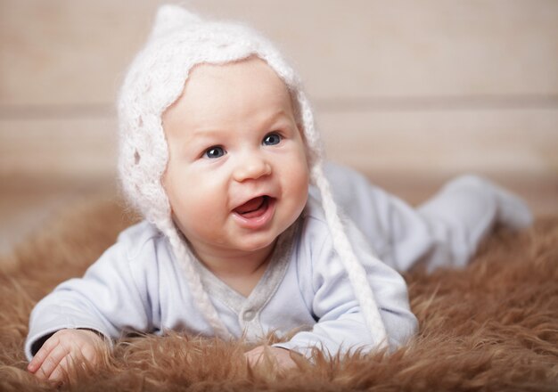 Adorable  baby boy in white hat