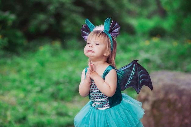 adorable baby in a dragon costume in the garden