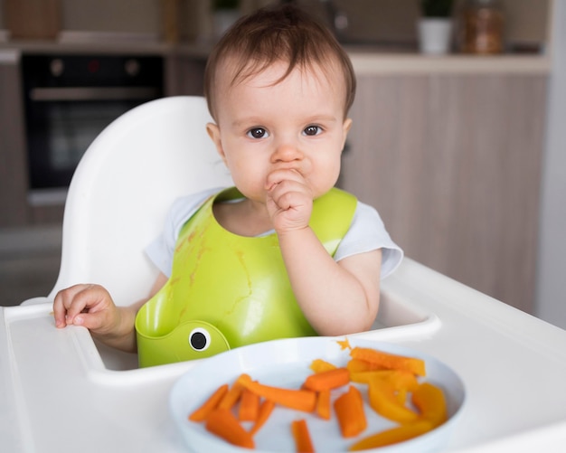 Photo adorable baby playing with food