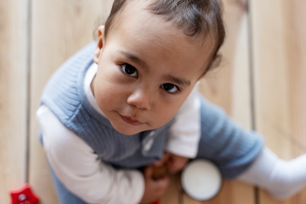 写真 床でおもちゃでポーズをとって遊んでいる愛らしい赤ちゃん