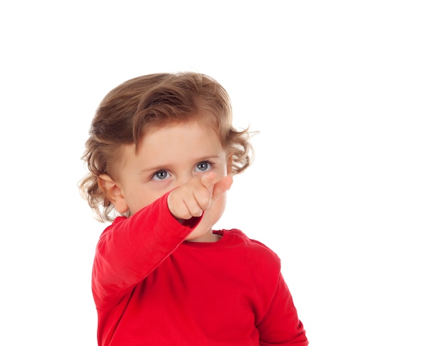 Adorable baby with red shirt pointing with his finger