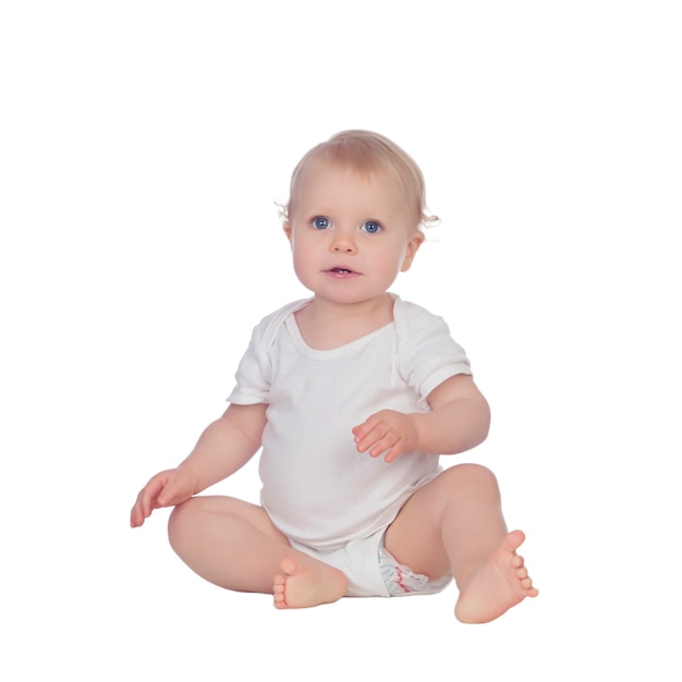 Adorable blonde baby sitting on the floor