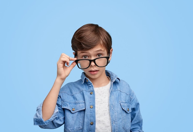 Adorable boy looking at camera with question