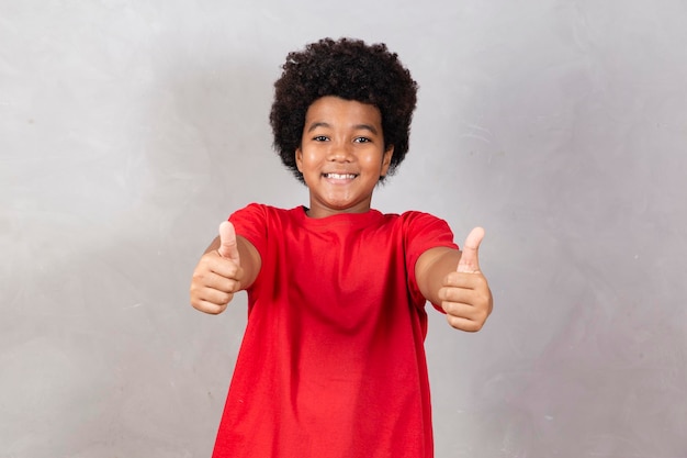 Adorable boy with thumb up making thumbs up ok