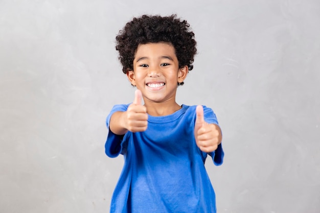 Adorable boy with thumb up making thumbs up ok