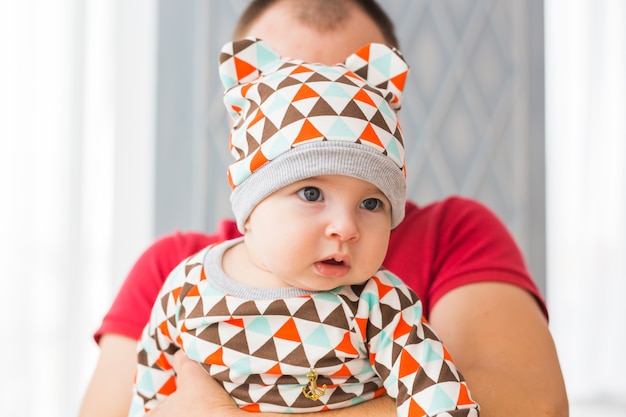 Adorable Caucasian baby and his father. Portrait of a three months old baby boy.