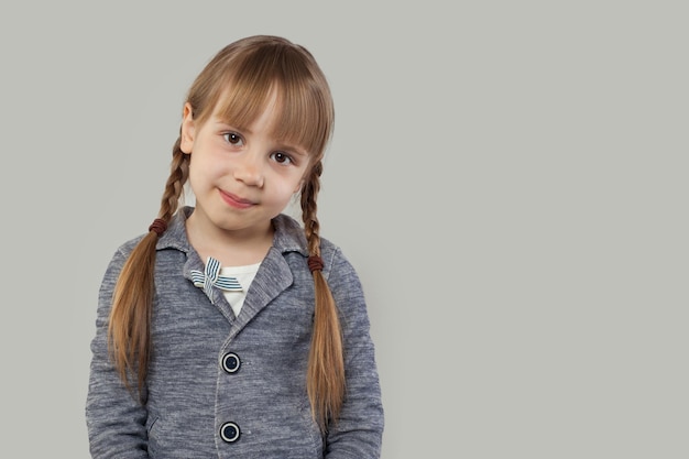 Adorable childgirl with pigtails on white background