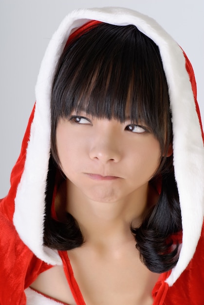 Adorable christmas girl with confused expression, closeup portrait.