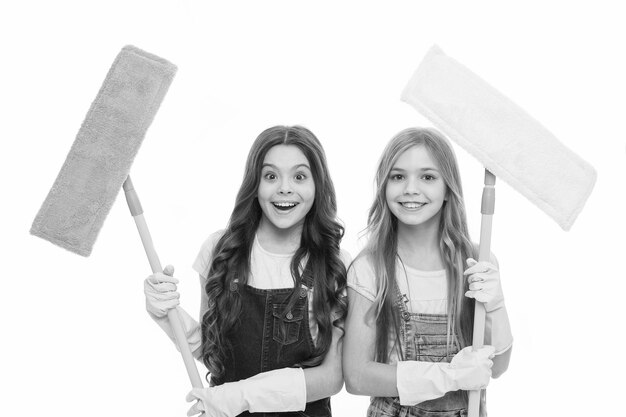 Photo adorable clean freaks cute girls holding mops for cleaning floor small cleaning ladies little cleaners with modern cleaning tools sanitation and cleaning service