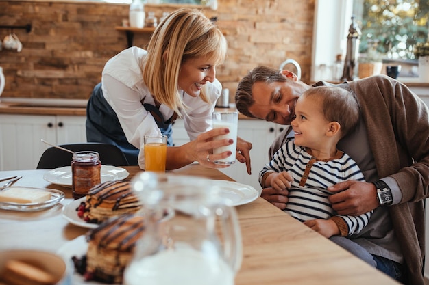 Adorable family having breakfast at home