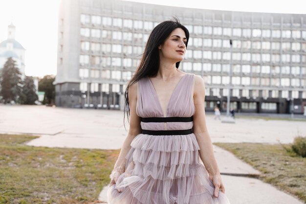 Adorable georgian woman walking in city Attractive model in fashion dress posing on the street Lifestyle