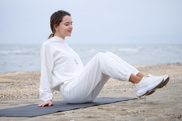 Adorable girl doing her exercises at the beach High quality photo