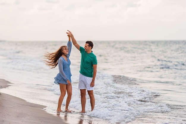 Adorable girl and happy dad having fun during beach vacation