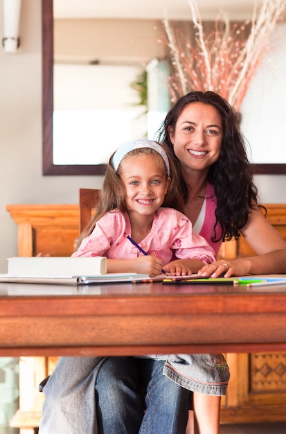 Adorable girl with her mother drawing 