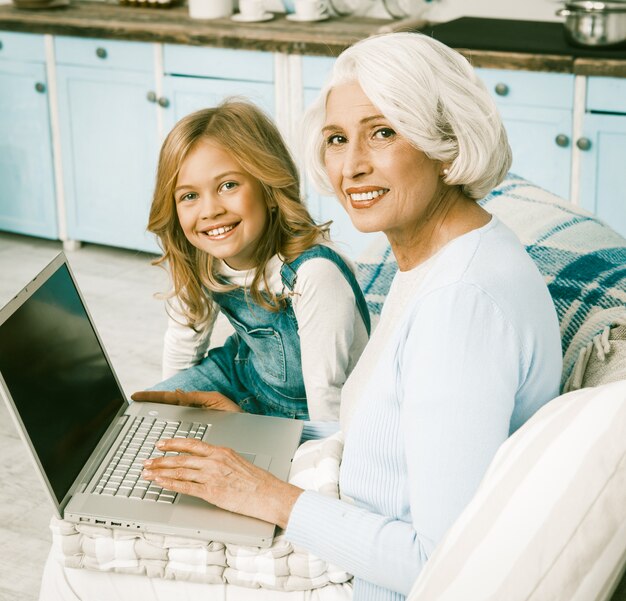 Adorable Granny And Little Girl Using Laptop