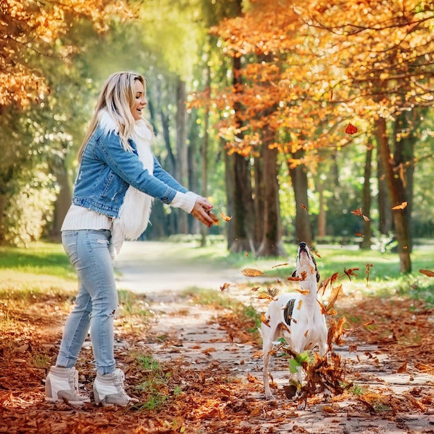 adorable happy blonde woman owner with her white whippet outdoor