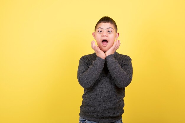 adorable kid in casual clothes standing and posing.