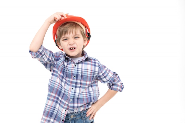 Adorable kid dressed as foreman in orange helmet and shirt 