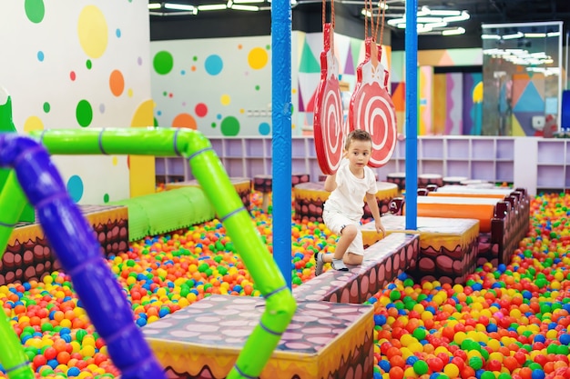 Adorable kid having fun in playing room