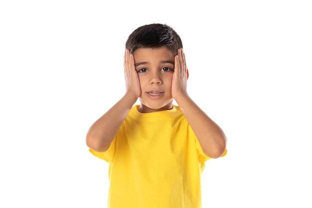 Adorable latin boy weraring a yellow t-shirt isolated on a white background