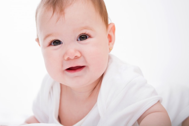 Adorable little baby girl on white.