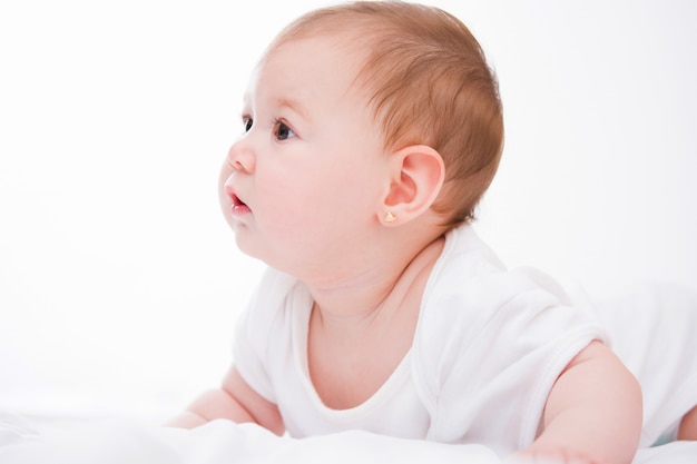 Adorable little baby girl on white.