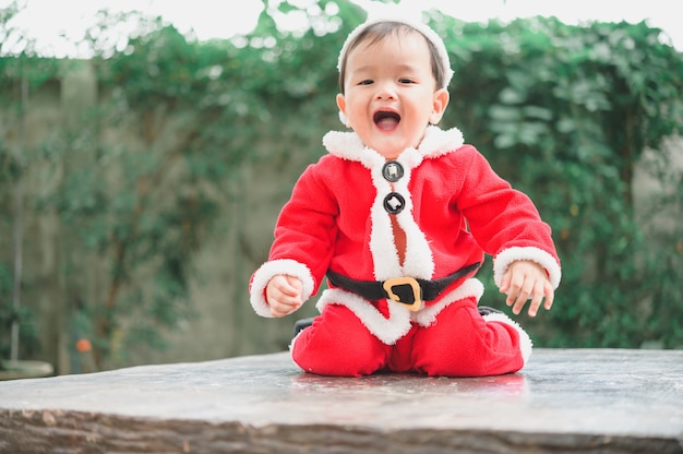 Adorable little baby in Santa Claus outfit