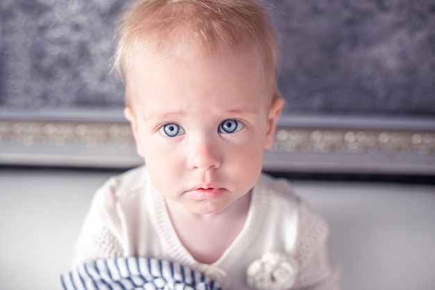 ブロンドの髪と青い目をした愛らしい小さな赤ちゃん